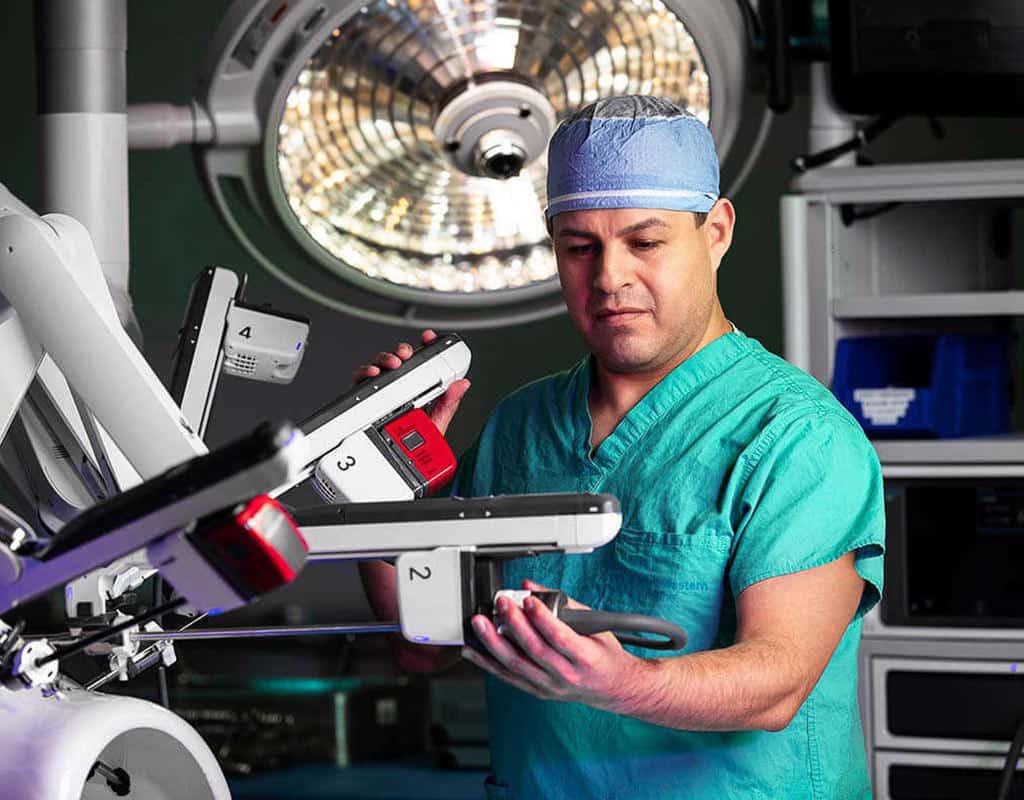 Chicago corporate photographer Tori Soper captures a surgeon working on a machine in an operating room.