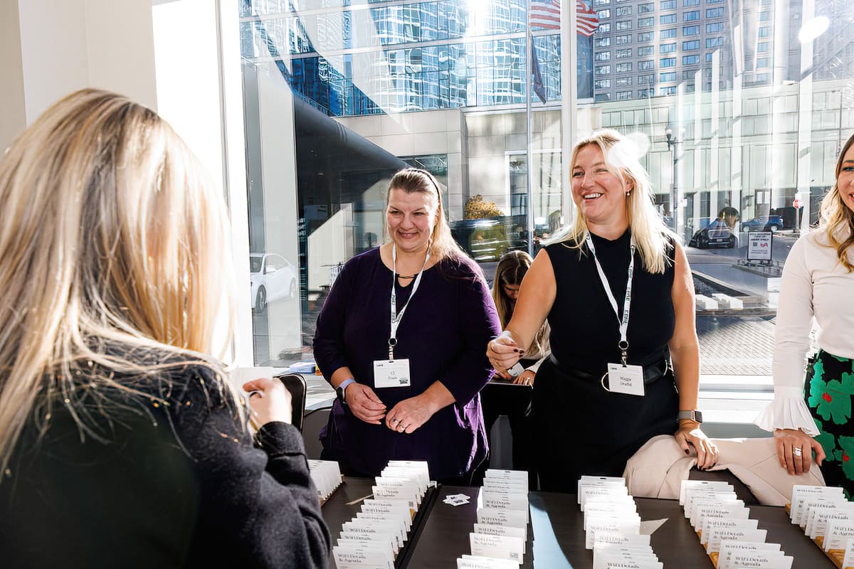 A group of women standing around a table at a Chicago corporate event.