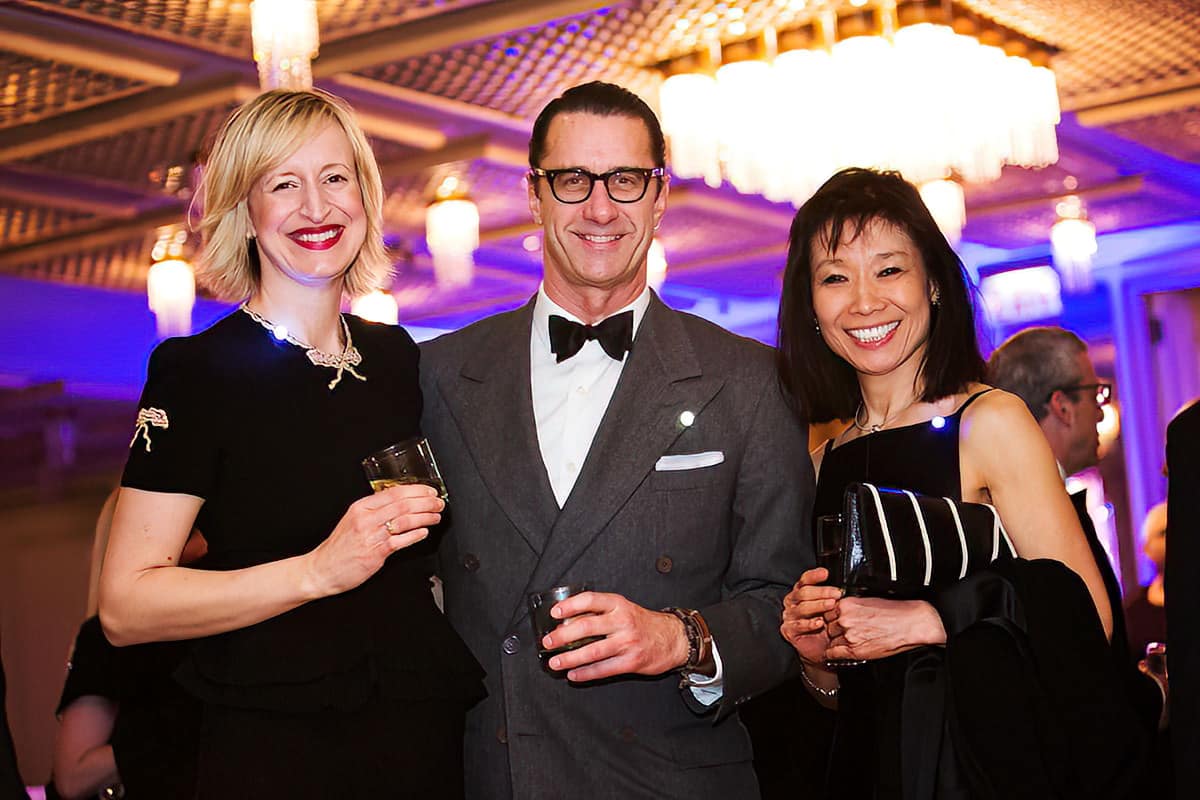 Three people posing for a photo at a Chicago corporate gala.