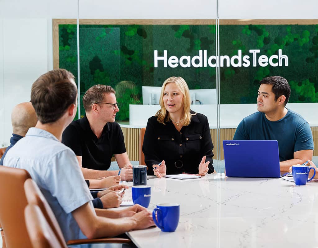 Team collaborating around a conference table at Headlands Tech, captured for Chicago Business Photography highlighting brand culture.