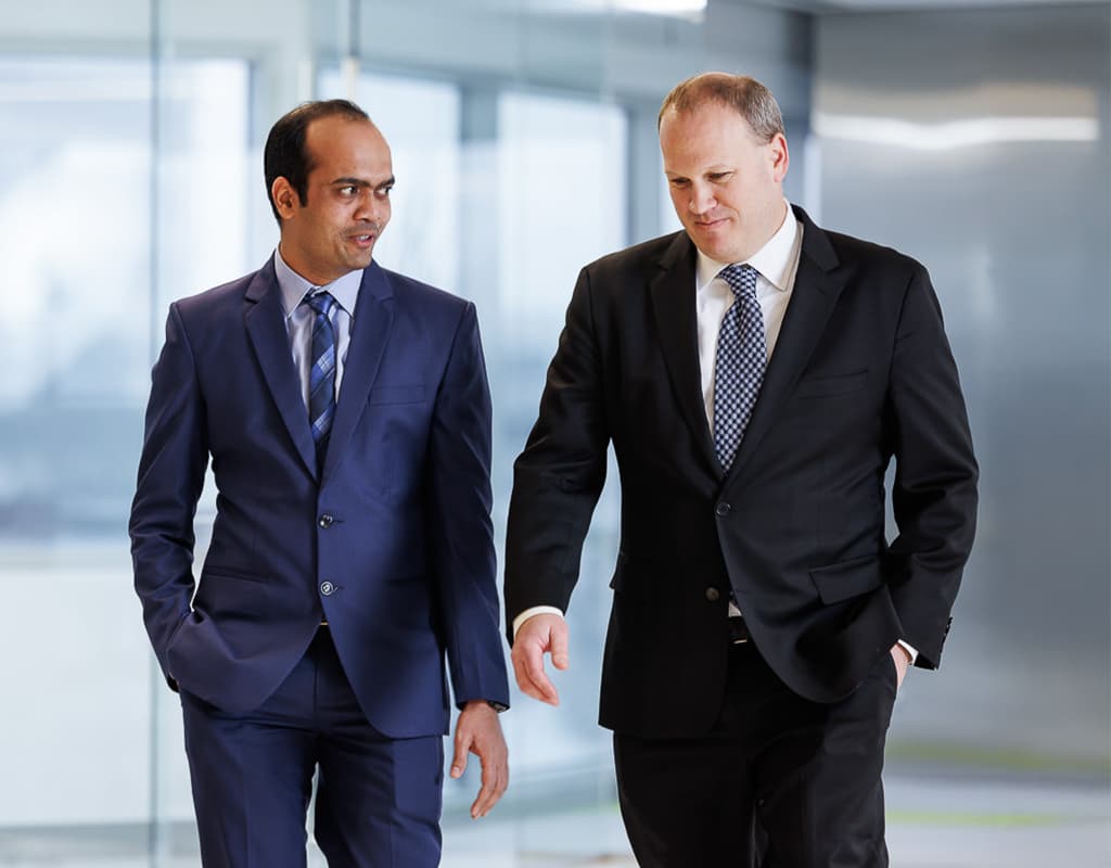 Two business professionals walking through a modern office hallway, Chicago Business Photography showcasing corporate leadership.