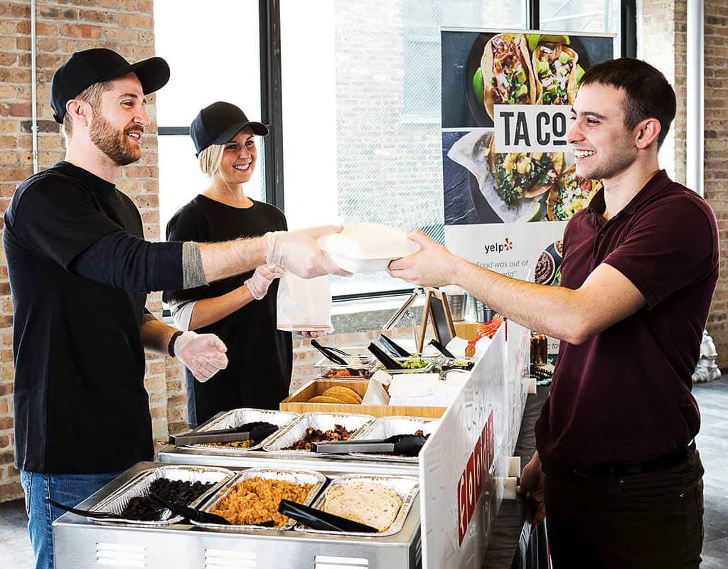 Employees enjoying a catered lunch at a company event, Chicago Business Photography capturing workplace culture.