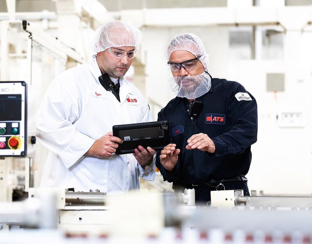 Team collaborating in a production facility, Chicago Business Photography showing operations and teamwork behind the brand.