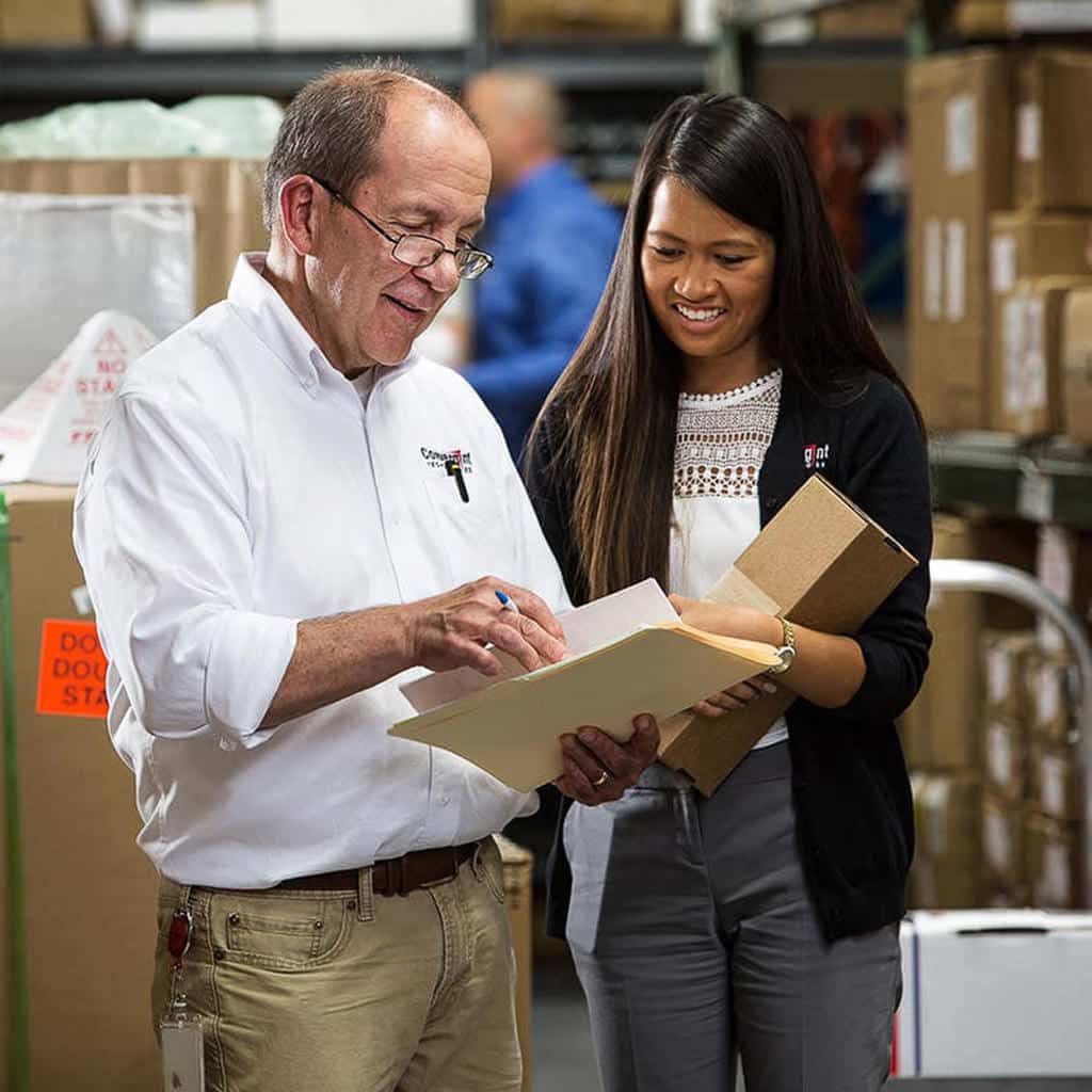 Corporate lifestyle photography of professionals reviewing materials in an industrial workplace