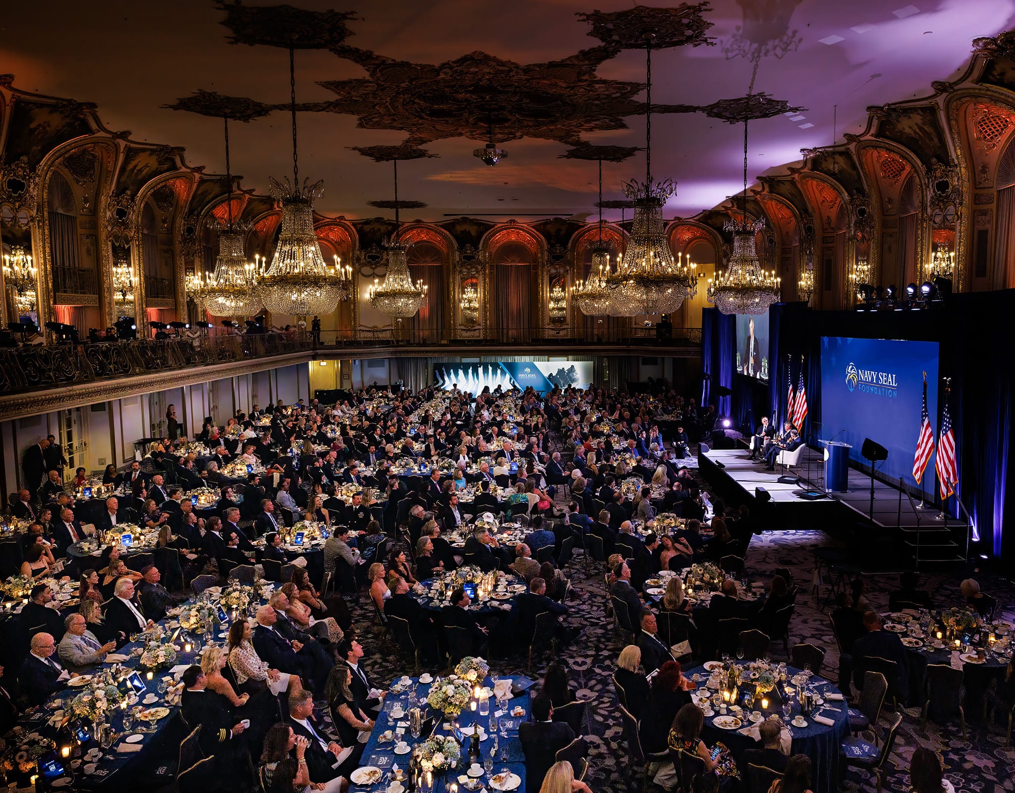Chicago corporate event photographer photographing ballroom gala with full audience.
