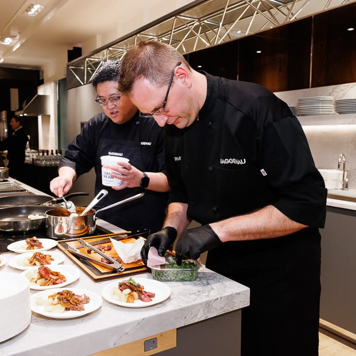 Two chefs plating gourmet food during a corporate event – Chicago corporate event photography