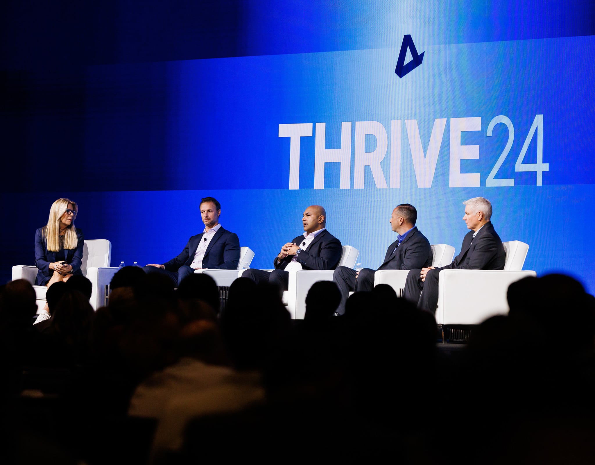 Chicago corporate event photography panel discussion at conference keynote stage with speakers and audience