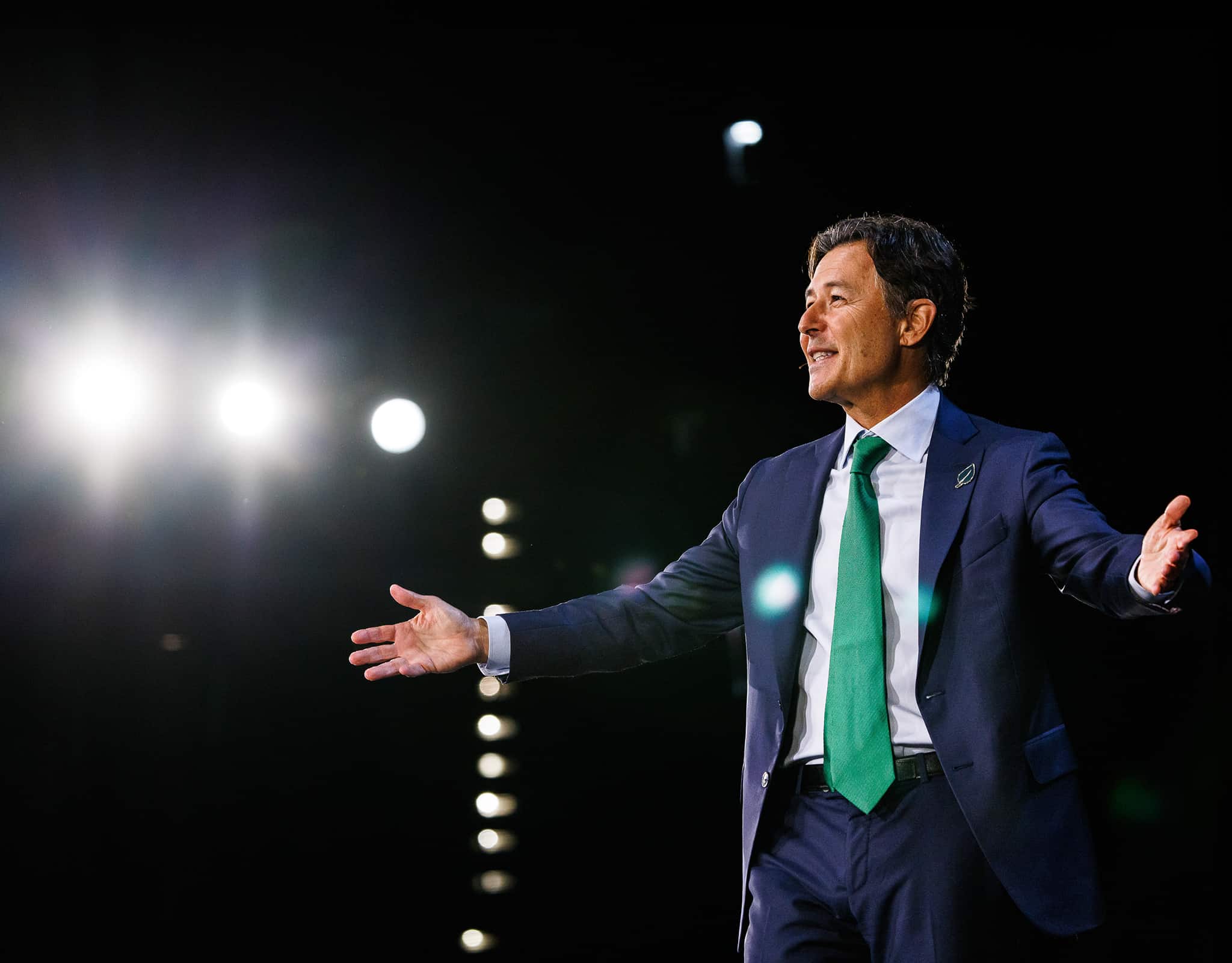 Chicago corporate event photography capturing keynote speaker presenting on stage with dramatic lighting