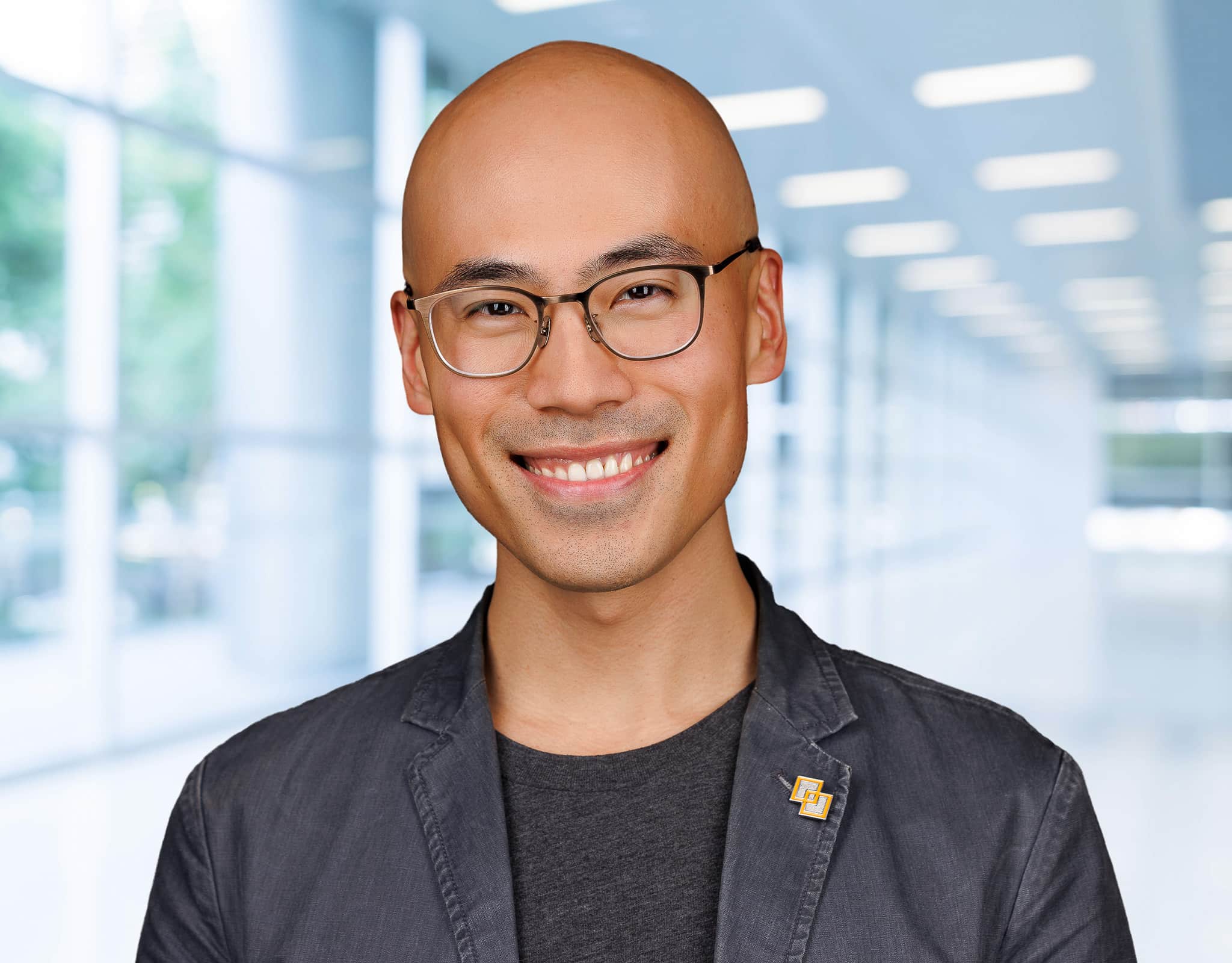 Executive headshot of man in modern office hallway for Chicago corporate headshots