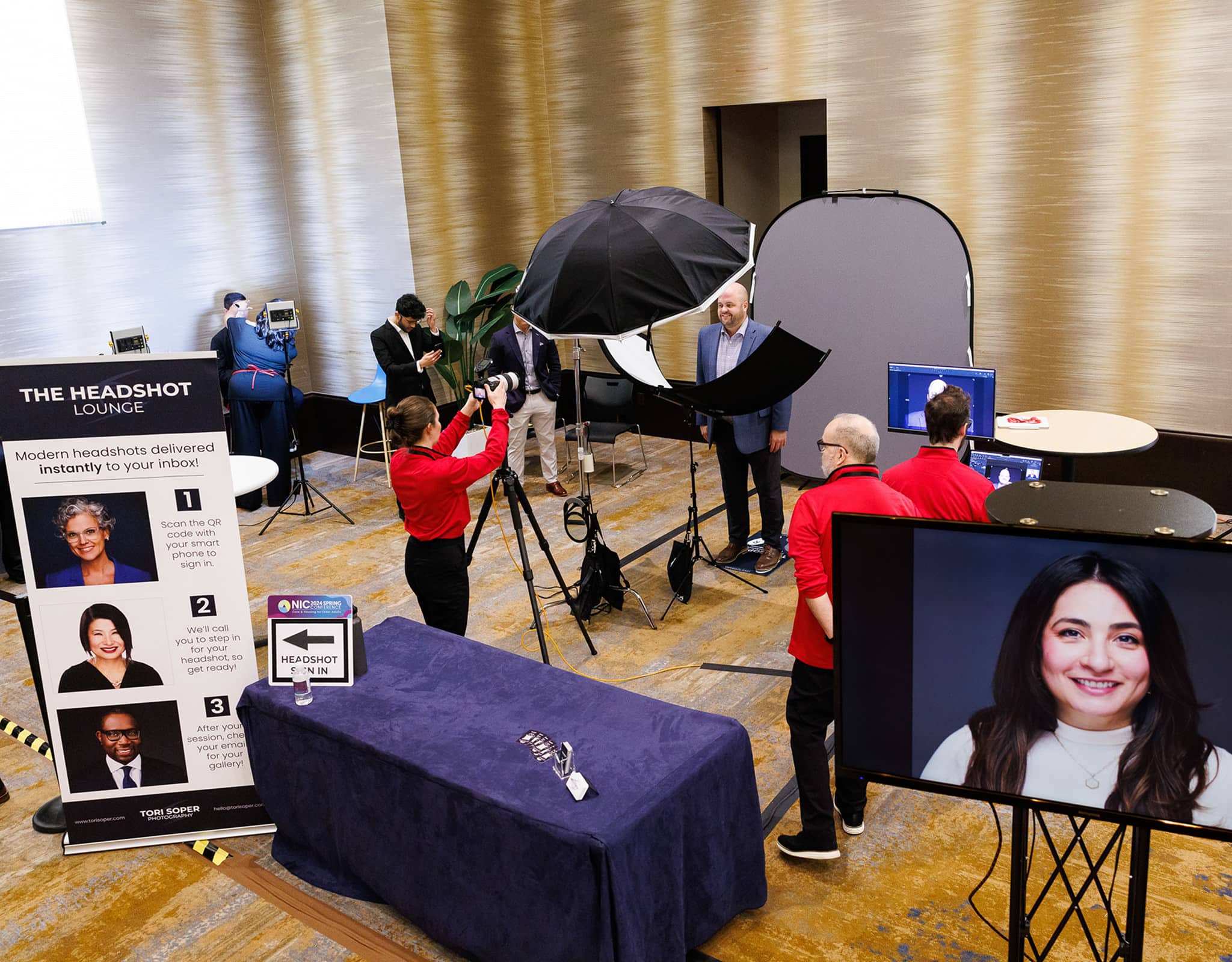 Chicago Headshot Lounge at corporate event with branded backdrop, professional lighting setup, and instant headshot display