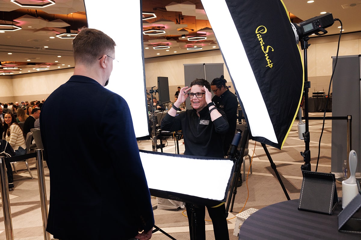Behind-the-scenes view of a Chicago Headshot Lounge setup at a corporate conference.