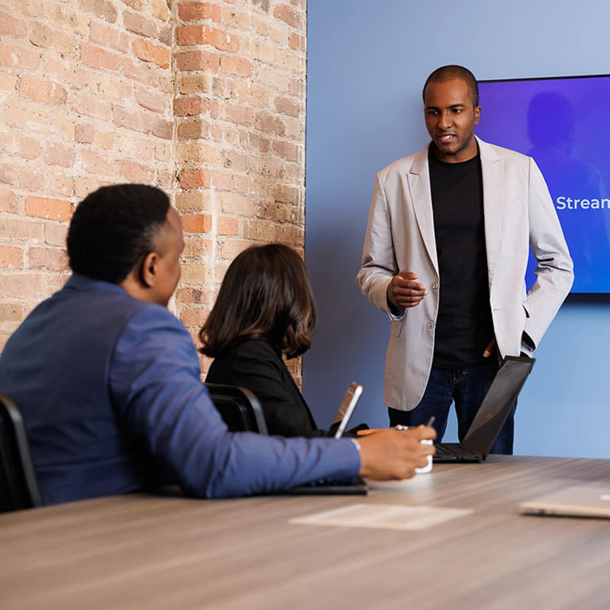 Chicago business photographer captures a professional leading a team meeting in a modern conference room