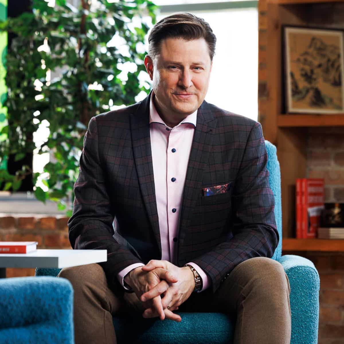 Chicago business photographer captures a confident executive seated in a modern office lounge