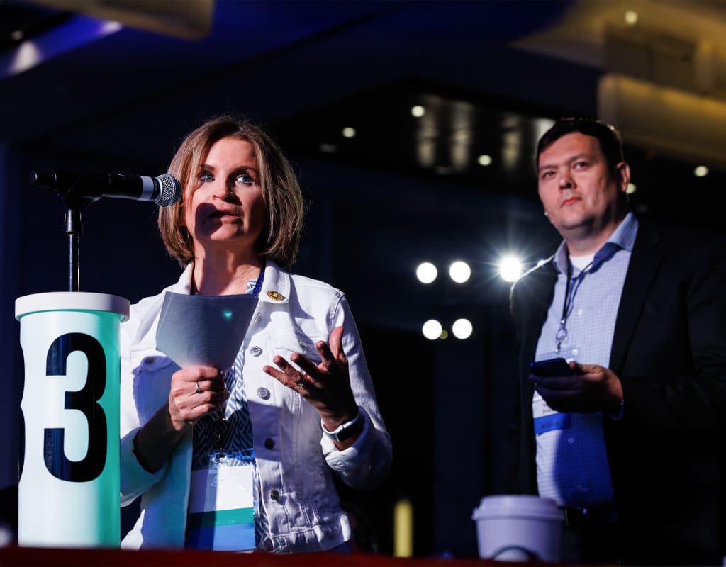 Audience member asking a question during a keynote panel session at a Chicago corporate event, photographed by Chicago corporate event photographer Tori Soper.