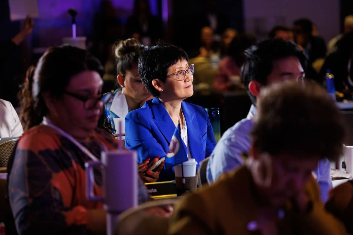 Audience members listening and taking notes during a corporate event session, photographed by Chicago corporate event photographer Tori Soper.