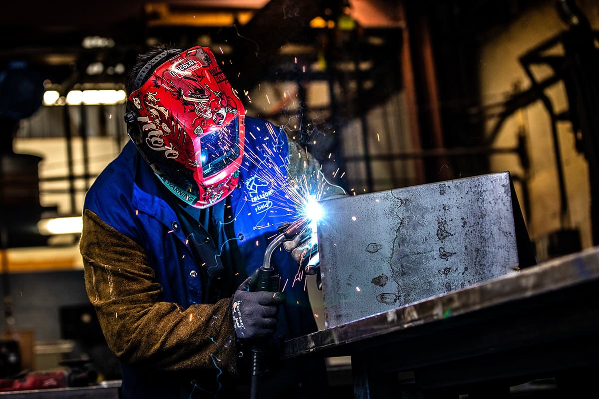 Industrial welder working on a metal project, captured for Chicago business photography to showcase manufacturing capabilities and craftsmanship.