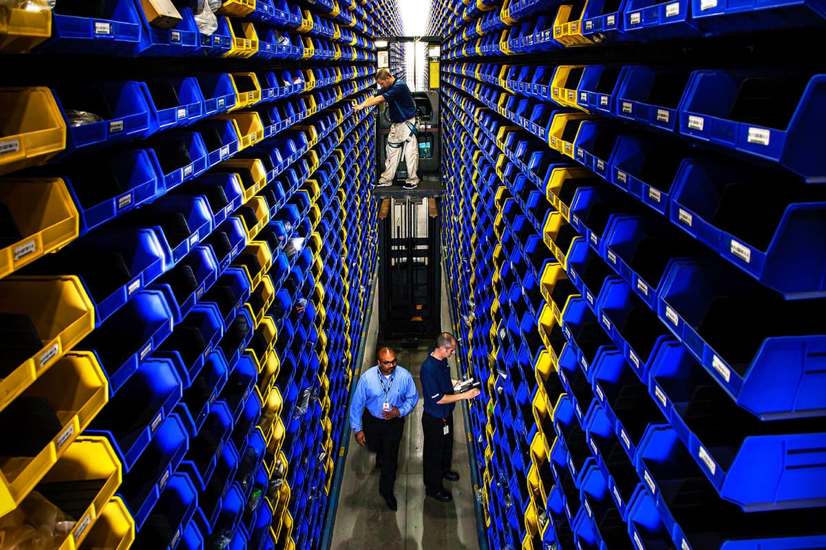 Professional standing in a large industrial warehouse, captured for Chicago business photography to emphasize scale and operational expertise.